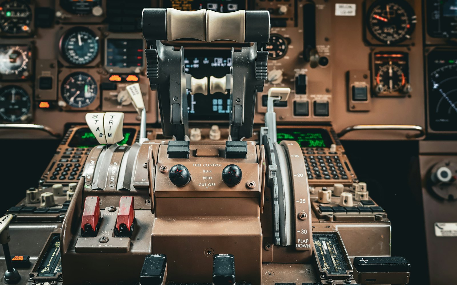 An airliner cockpit: throttle levers and instruments